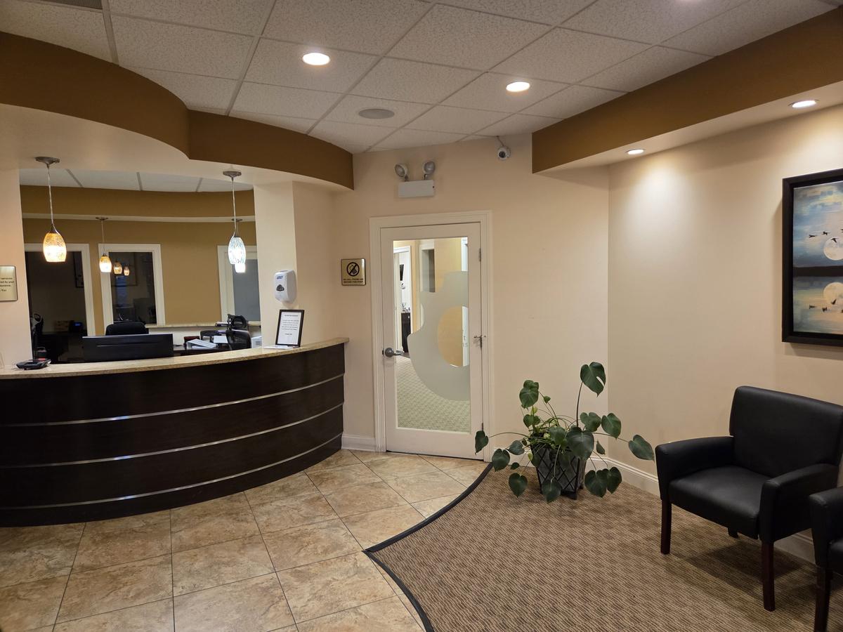 Front lobby and curved reception desk at Comfort Family Dental in Beverly, Chicago
