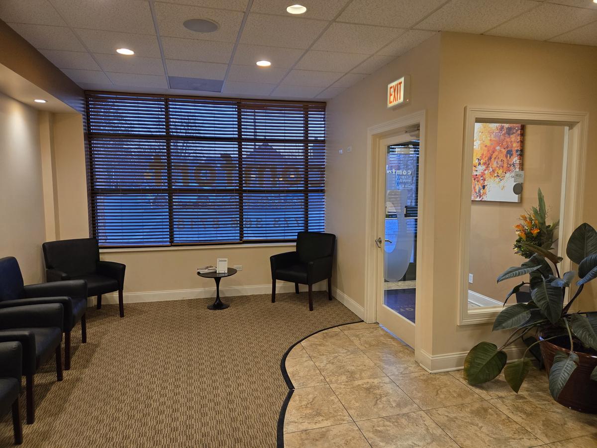 Waiting room with seating and street-facing windows at Comfort Family Dental on West 95th Street